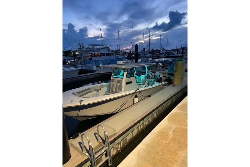 Slide: The Image of 2024 Sea Pro 322 Offshore boat docked at marina during sunset. - 12