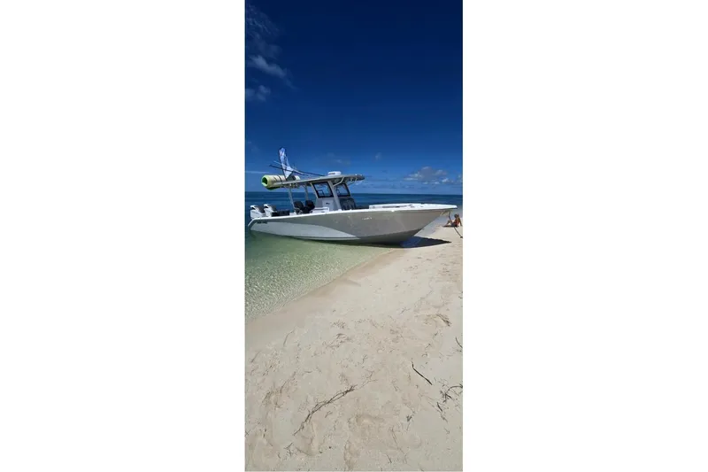 Slide: The Image of 2024 Sea Pro 322 Offshore boat on sandy beach under clear blue sky. - 14