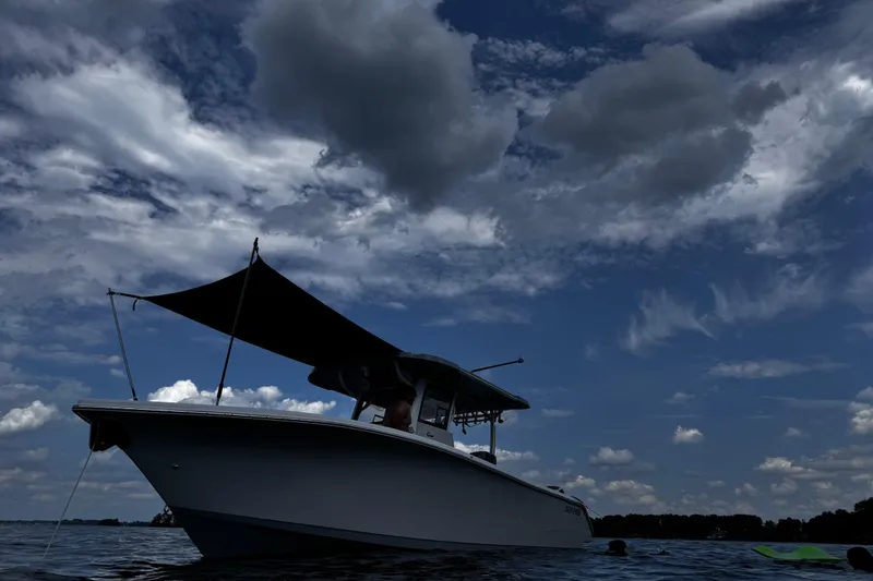 Slide: The Image of 2024 Sea Pro 322 Offshore boat under dramatic cloudy sky on water. - 15