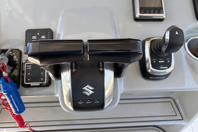 Slide: The Image of 2024 Sea Pro 322 Offshore boat controls with Suzuki throttle and joystick. - 26