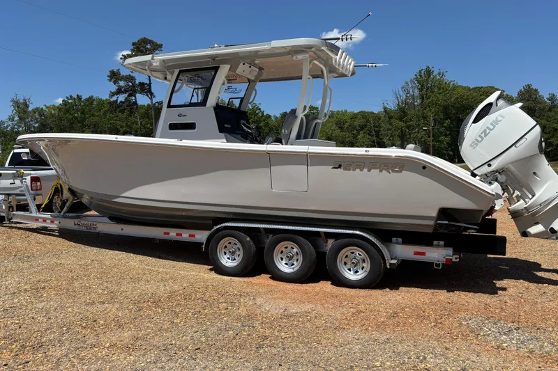 Slide: The Image of 2024 Sea Pro 322 Offshore boat on trailer, featuring Suzuki outboard engines. - 3