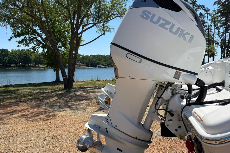 Slide: The Image of 2024 Sea Pro 322 Offshore boat with Suzuki outboard motor by a scenic lake. - 5