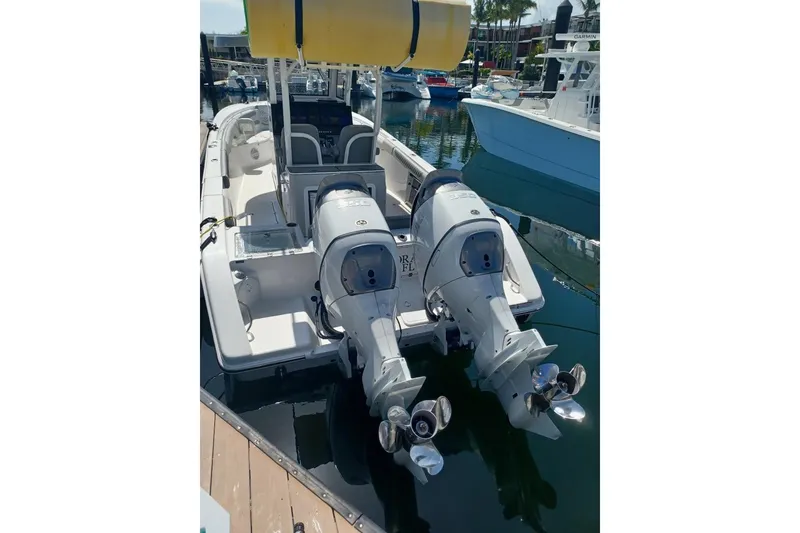 Slide: The Image of 2024 Sea Pro 322 Offshore boat with dual outboard engines docked at marina. - 9