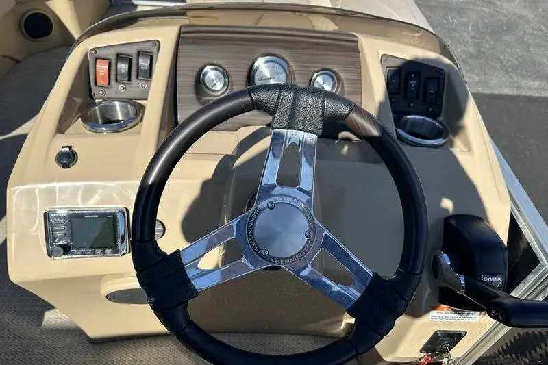 Slide: The Image of Steering console of a 2018 Bennington 23 SPDX boat with controls and gauges. - 11
