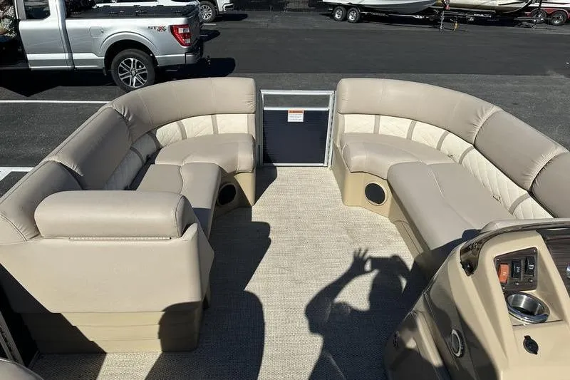 Slide: The Image of 2018 Bennington 23 SPDX pontoon boat interior with beige seating and control panel. - 13