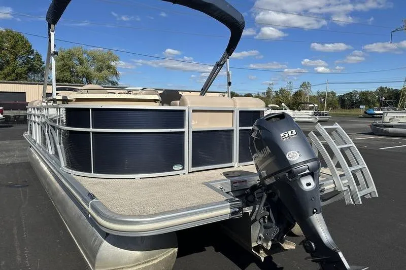 Slide: The Image of 2018 Bennington 23 SPDX pontoon boat with Yamaha 50 engine, parked outdoors. - 4