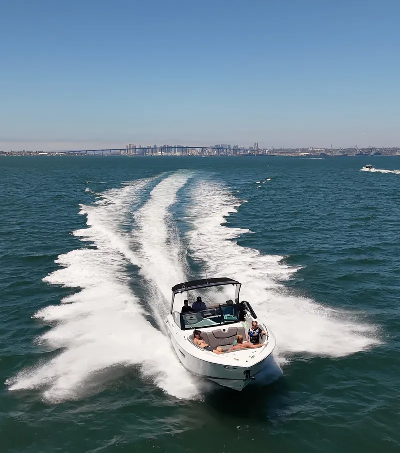 Slide: The Image of A white motorboat speeds across the water, leaving a trail of spray behind. - 6