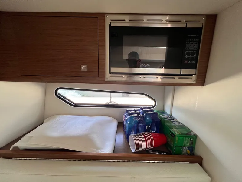 Slide: The Image of Interior of 2019 Cruisers Yachts 338 CX with microwave and drinks. - 25