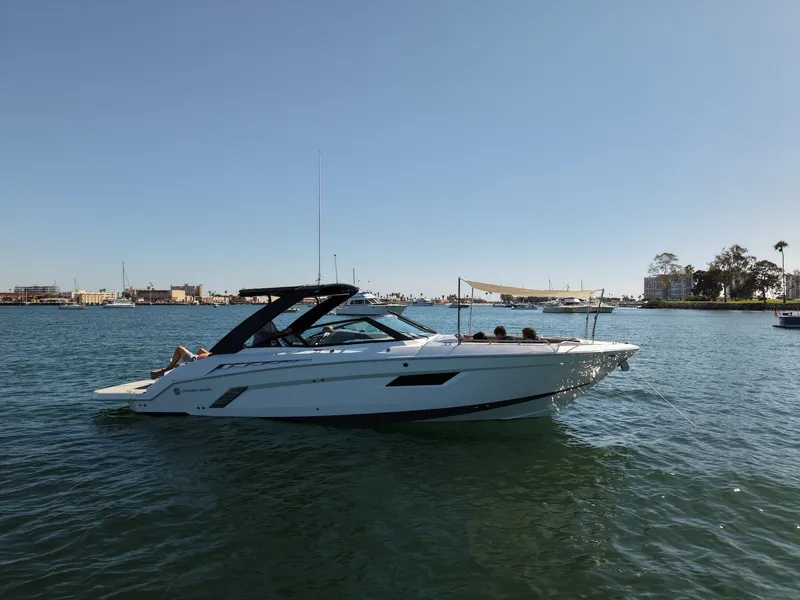 The Image of 2019 Cruisers Yachts 338 CX South Beach Bow Rider on calm water with sunshade. - 5