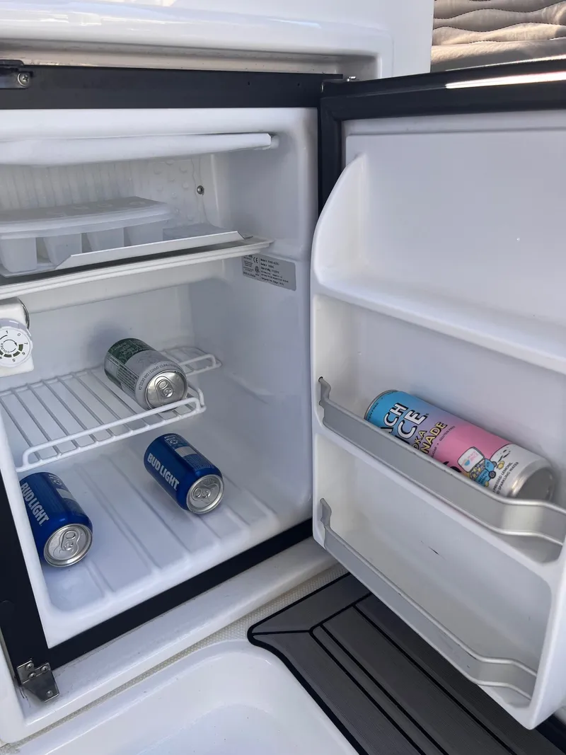 Slide: The Image of Refrigerator with beverage cans on a 2019 Cruisers Yachts 338 CX. - 39