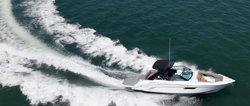 Slide: The Image of A white motorboat speeds across the water, leaving a trail of spray behind. - 8