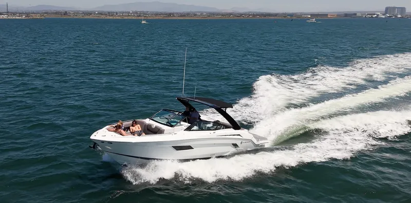 Slide: The Image of A 2019 Cruisers Yachts 338 CX South Beach Bow Rider speeding across the water. - 10
