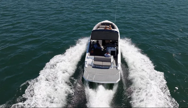 Slide: The Image of A 2019 Cruisers Yachts 338 CX South Beach Bow Rider speeding across the water. - 11