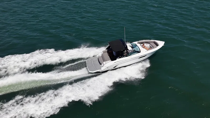 Slide: The Image of A white sport boat speeds across the water, leaving a trail of splashing wake. - 9
