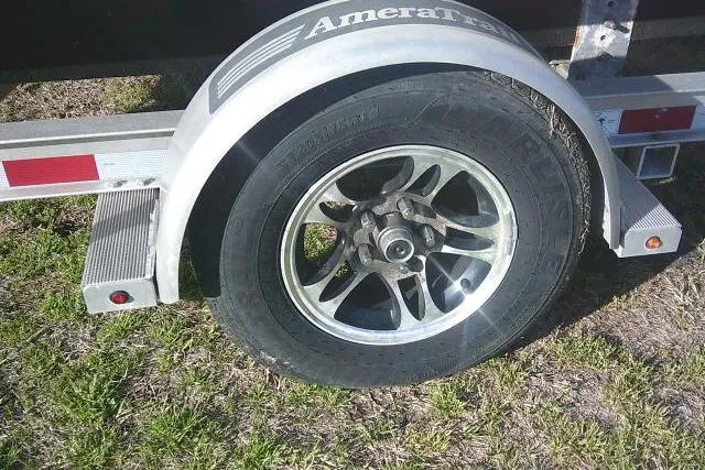 Slide: The Image of Trailer wheel of a 2017 Sportsman Masters 207 Bay Boat on grass. - 11