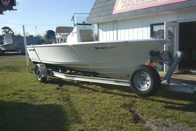 Slide: The Image of 2017 Sportsman Masters 207 Bay Boat on trailer, parked outside a building. - 2