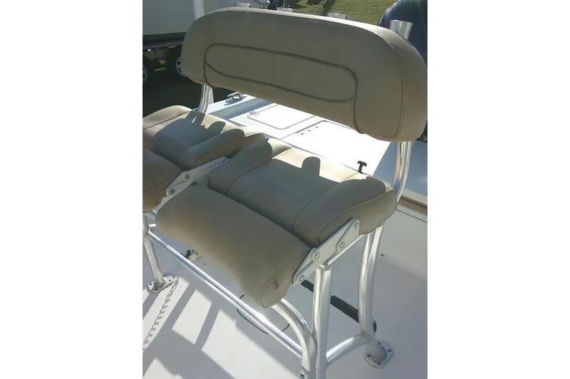 Slide: The Image of 2017 Sportsman Masters 207 Bay Boat seat with beige upholstery and metal frame. - 21