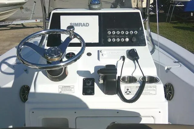 Slide: The Image of 2017 Sportsman Masters 207 Bay Boat console with steering wheel and Simrad display. - 22
