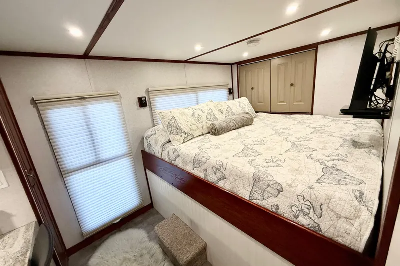 Slide: The Image of Cozy bedroom in 2005 Twin Anchors 6816 Arizona Edition Yacht House with map-themed bedding. - 16