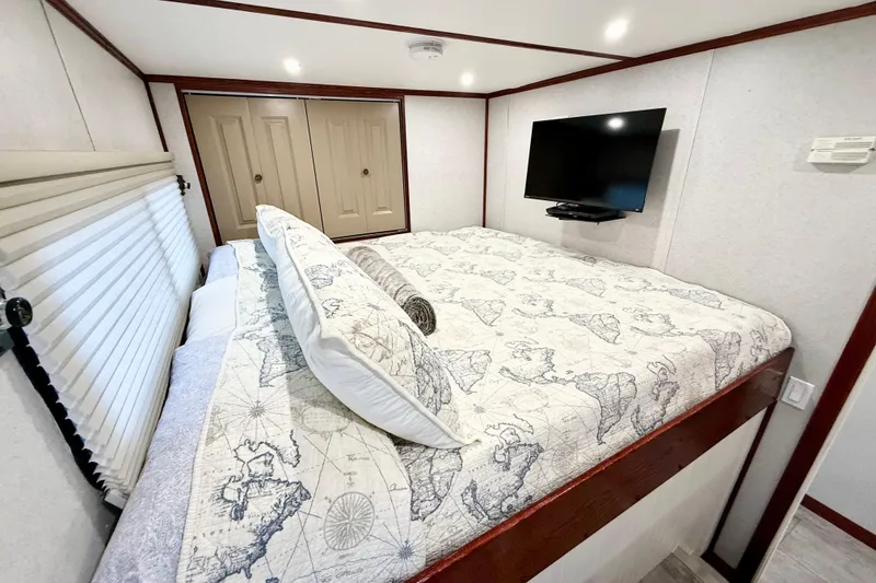 Slide: The Image of Luxurious bedroom in 2005 Twin Anchors 6816 Arizona Edition Yacht House with TV and map-themed bedding. - 17