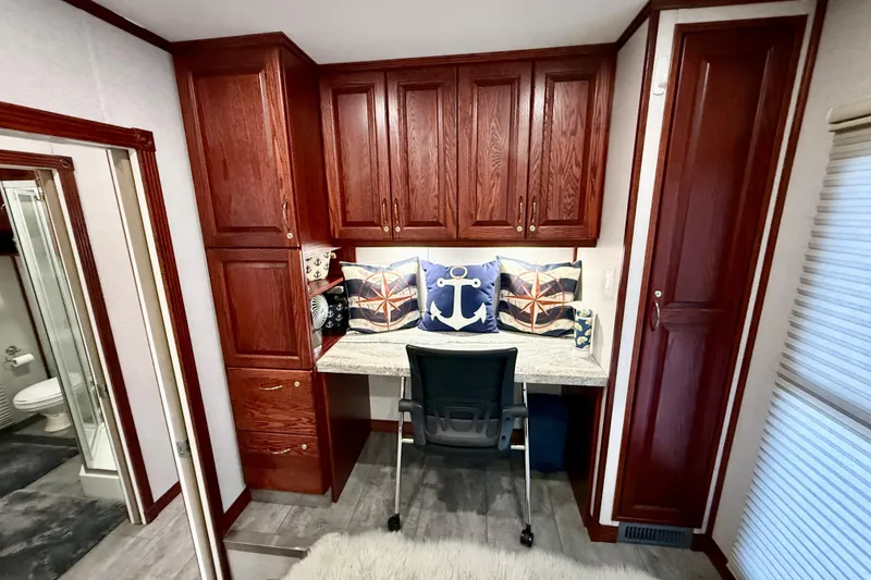 Slide: The Image of Cozy workspace in 2005 Twin Anchors yacht with wooden cabinets and nautical-themed decor. - 19