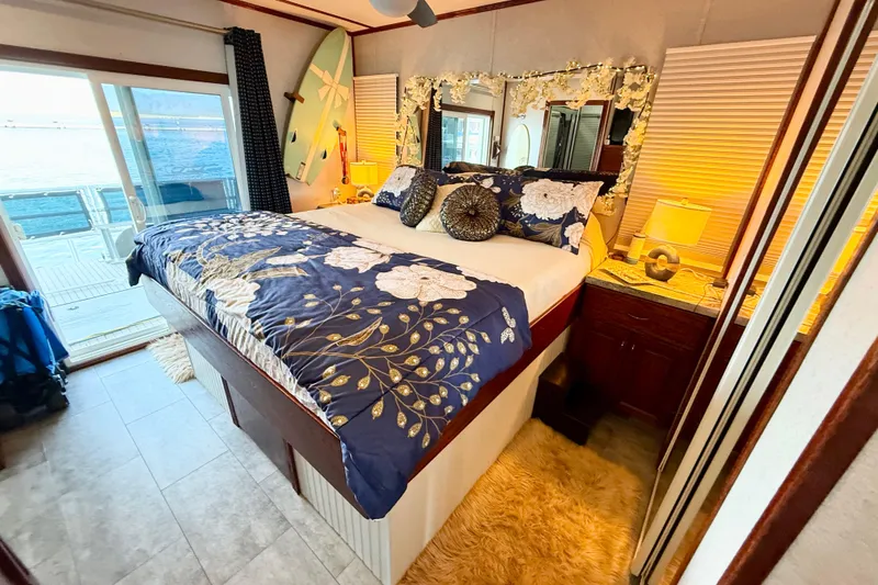 Slide: The Image of Luxurious bedroom in 2005 Twin Anchors Yacht House with elegant decor and waterfront view. - 22