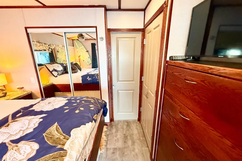 Slide: The Image of Cozy bedroom in 2005 Twin Anchors Yacht House with floral bedding and mirrored closet. - 24