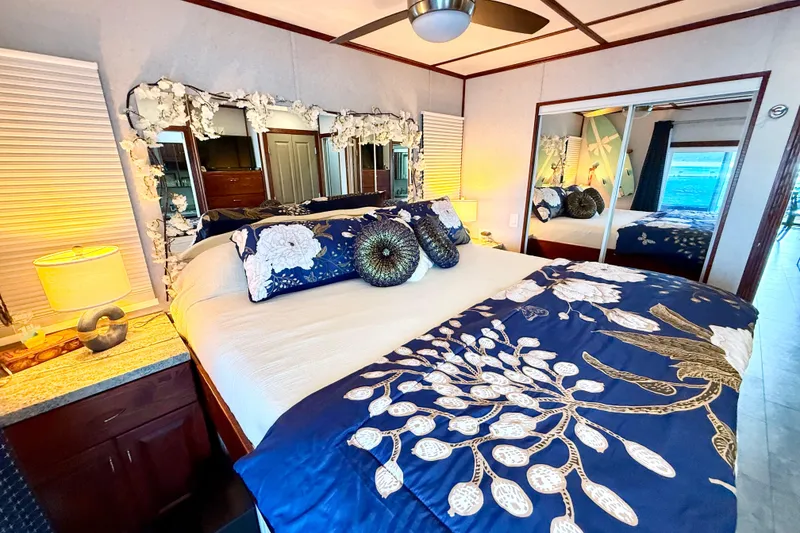 Slide: The Image of Luxurious bedroom in 2005 Twin Anchors Yacht House with elegant decor and floral bedding. - 25