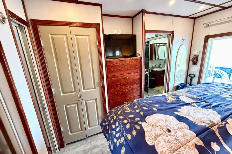 Slide: The Image of Interior of 2005 Twin Anchors 6816 Arizona Edition Yacht House bedroom with floral bedding. - 26