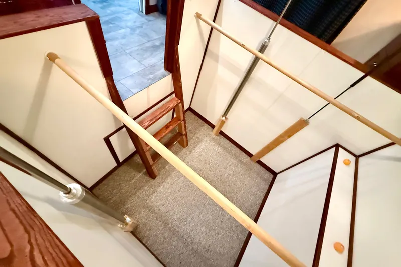 Slide: The Image of Interior view of 2005 Twin Anchors 6816 Arizona Edition Yacht House, featuring wooden and metal railings. - 28