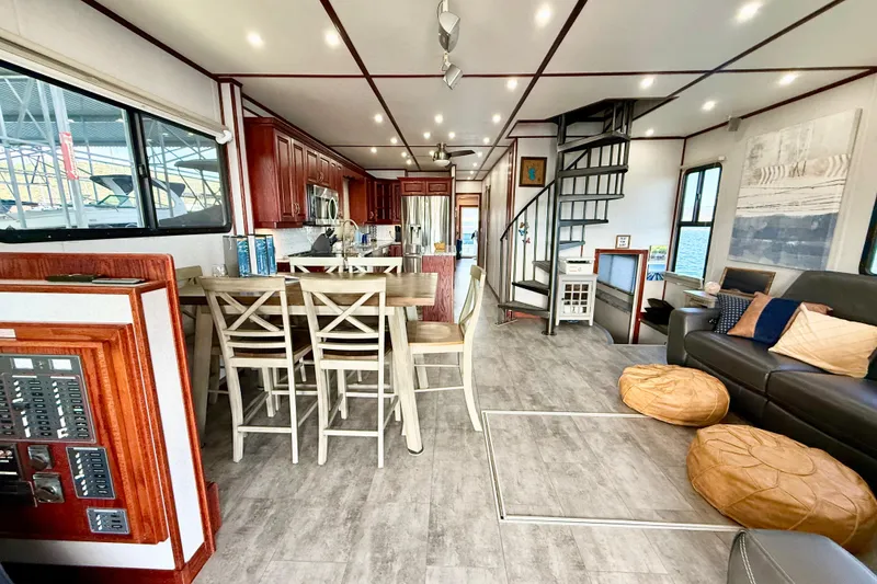 Slide: The Image of Interior of 2005 Twin Anchors 6816 Arizona Edition Yacht House, featuring modern kitchen and spiral staircase. - 3