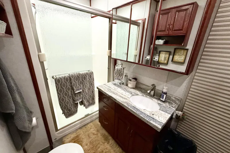 Slide: The Image of Luxurious bathroom in 2005 Twin Anchors Yacht House, featuring elegant wood cabinetry and modern fixtures. - 32