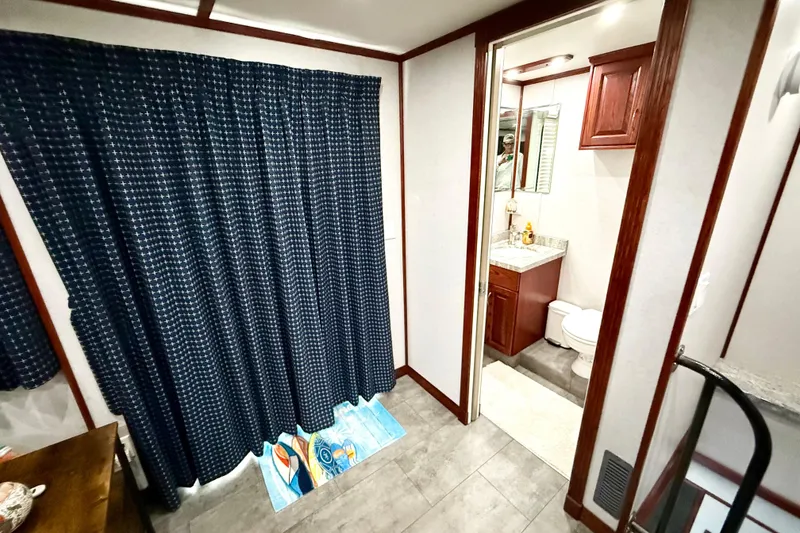 Slide: The Image of Interior of 2005 Twin Anchors Yacht House with bathroom and blue curtains. - 39