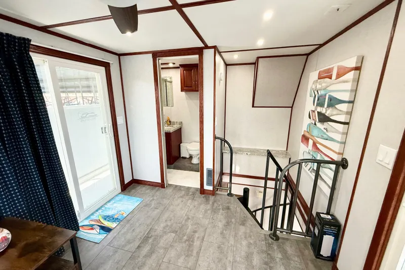 Slide: The Image of Interior of 2005 Twin Anchors 6816 Arizona Edition Yacht House, featuring modern decor and staircase. - 40