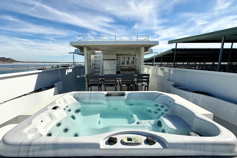 Slide: The Image of Luxurious 2005 Twin Anchors yacht house with hot tub and outdoor seating. - 44