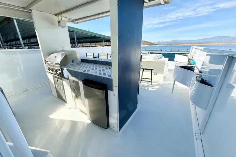 Slide: The Image of Outdoor kitchen on 2005 Twin Anchors 6816 Arizona Edition Yacht House, featuring grill and mini fridge. - 45