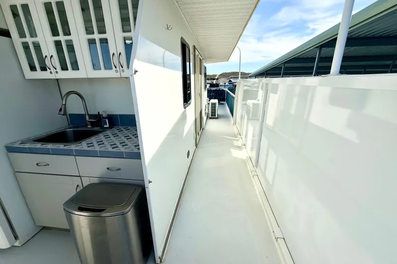 Slide: The Image of Narrow walkway on 2005 Twin Anchors 6816 Arizona Edition Yacht House with outdoor sink and cabinets. - 48