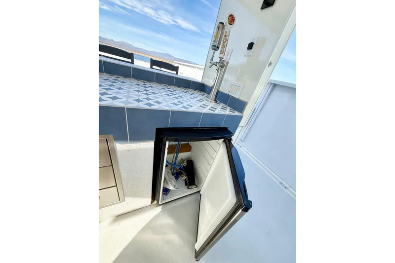 Slide: The Image of Outdoor bar area on 2005 Twin Anchors Yacht House, featuring a mini fridge and tap. - 51