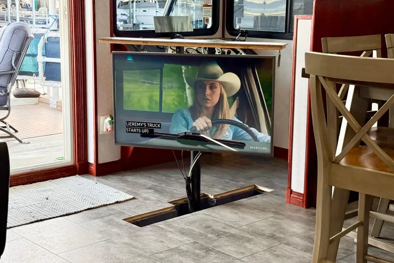 Slide: The Image of Interior of 2005 Twin Anchors yacht with pop-up TV showing a scene from "Heartland." - 57