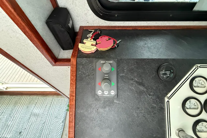 Slide: The Image of Control panel of 2005 Twin Anchors 6816 Arizona Edition Yacht House with keys and gauges. - 59