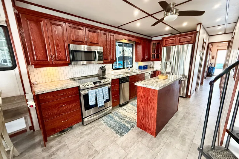Slide: The Image of Luxurious kitchen in 2005 Twin Anchors Yacht House, featuring modern appliances and elegant wood cabinetry. - 6
