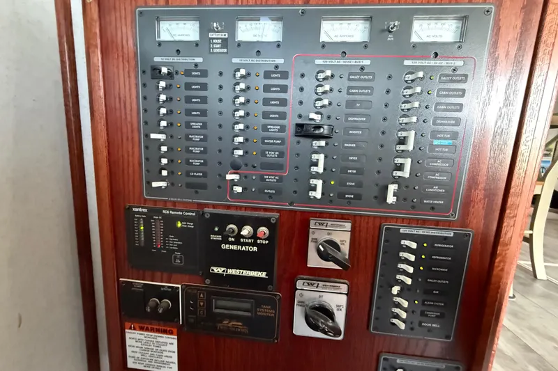 Slide: The Image of Control panel of 2005 Twin Anchors 6816 Arizona Edition Yacht House, featuring various switches and meters. - 61