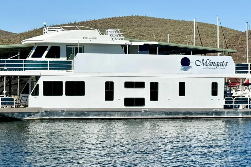 Slide: The Image of 2005 Twin Anchors 6816 Arizona Edition Yacht House on serene water with scenic backdrop. - 63