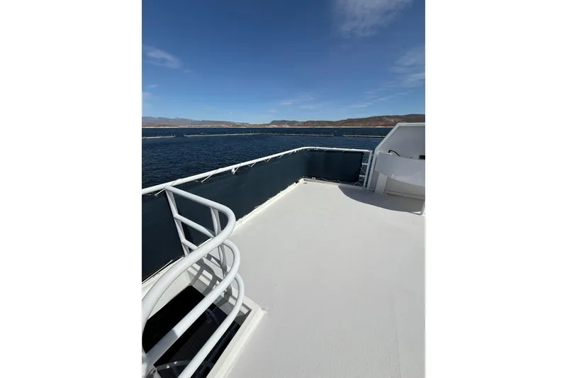 Slide: The Image of Upper deck of 2005 Twin Anchors 6816 Arizona Edition Yacht House, overlooking serene waters. - 66