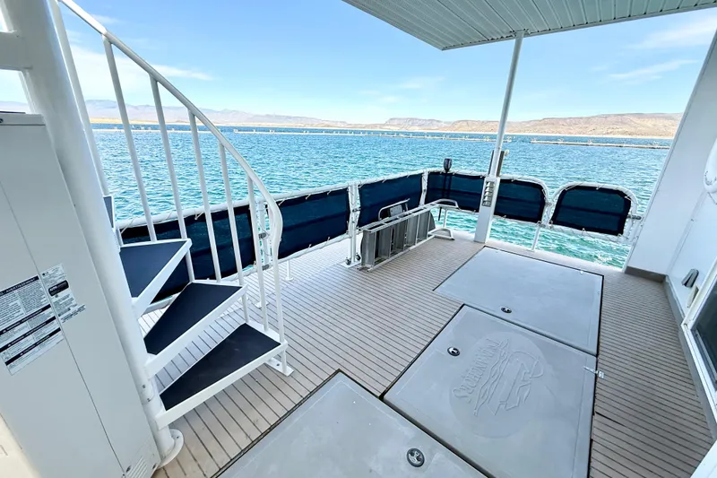 Slide: The Image of 2005 Twin Anchors 6816 Arizona Edition Yacht House deck with spiral staircase and scenic water view. - 67