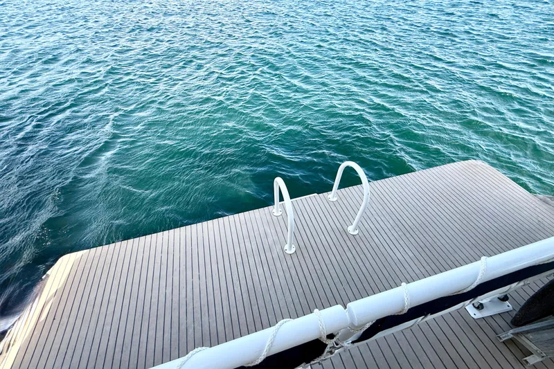 Slide: The Image of Swim platform of 2005 Twin Anchors 6816 Arizona Edition Yacht House on water. - 68