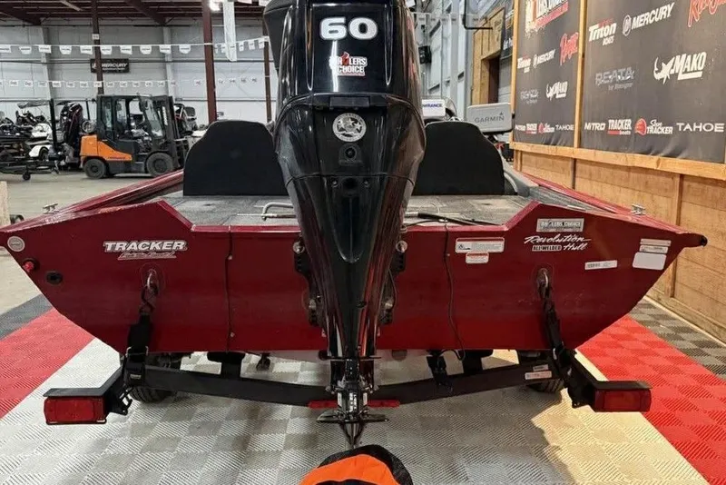 Slide: The Image of 2019 Tracker Pro Team 175 TXW boat with 60 HP engine in showroom. - 2