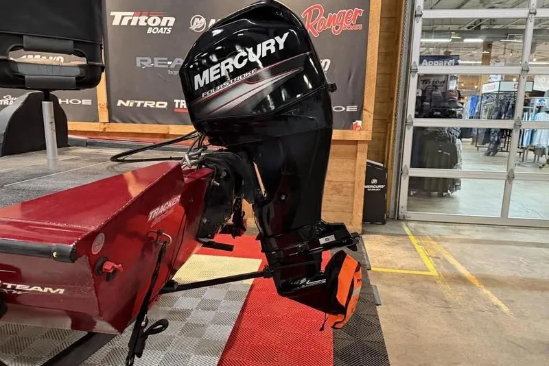 Slide: The Image of 2019 Tracker Pro Team 175 TXW boat with Mercury FourStroke engine in showroom. - 3