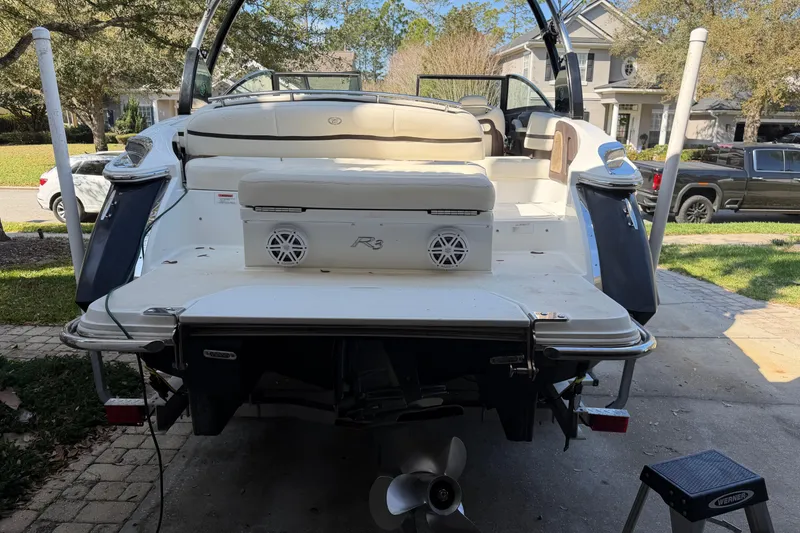 Slide: The Image of 2017 Cobalt R3 boat in driveway, rear view with speakers and seating. - 10