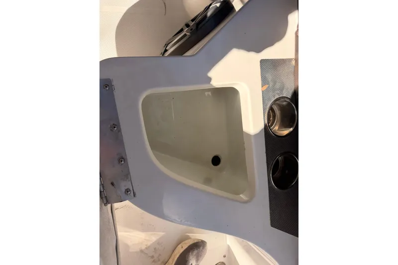 Slide: The Image of 2017 Cobalt R3 boat interior with built-in storage compartment and cup holders. - 17